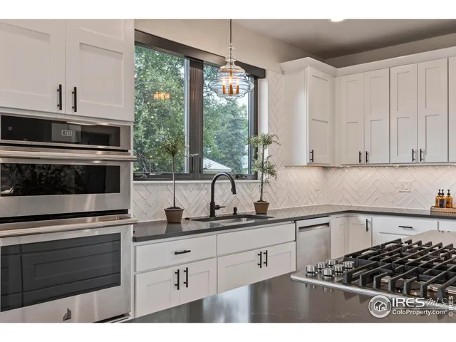 a kitchen with stainless steel appliances a stove sink and cabinets