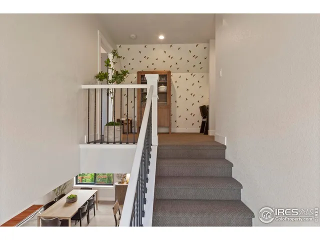 a view of a hallway and a kitchen with furniture