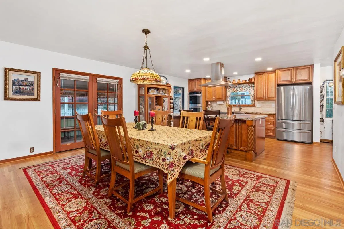 1675 Chase Lane El Cajon, CA 92020 - Photo 11 of 32 a view of a dining room and livingroom with furniture wooden floor a rug and a chandelier
