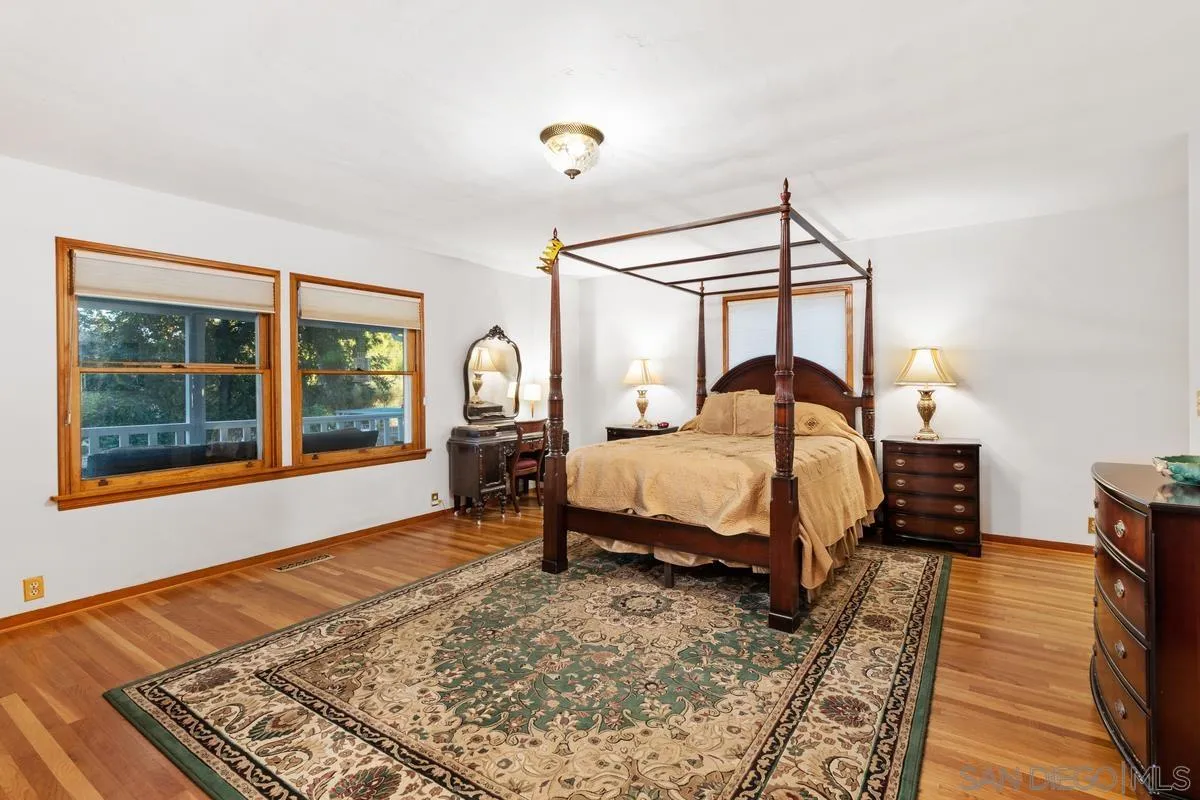 1675 Chase Lane El Cajon, CA 92020 - Photo 13 of 32 a bedroom with a bed next to a window with a flat tv screen and a dresser