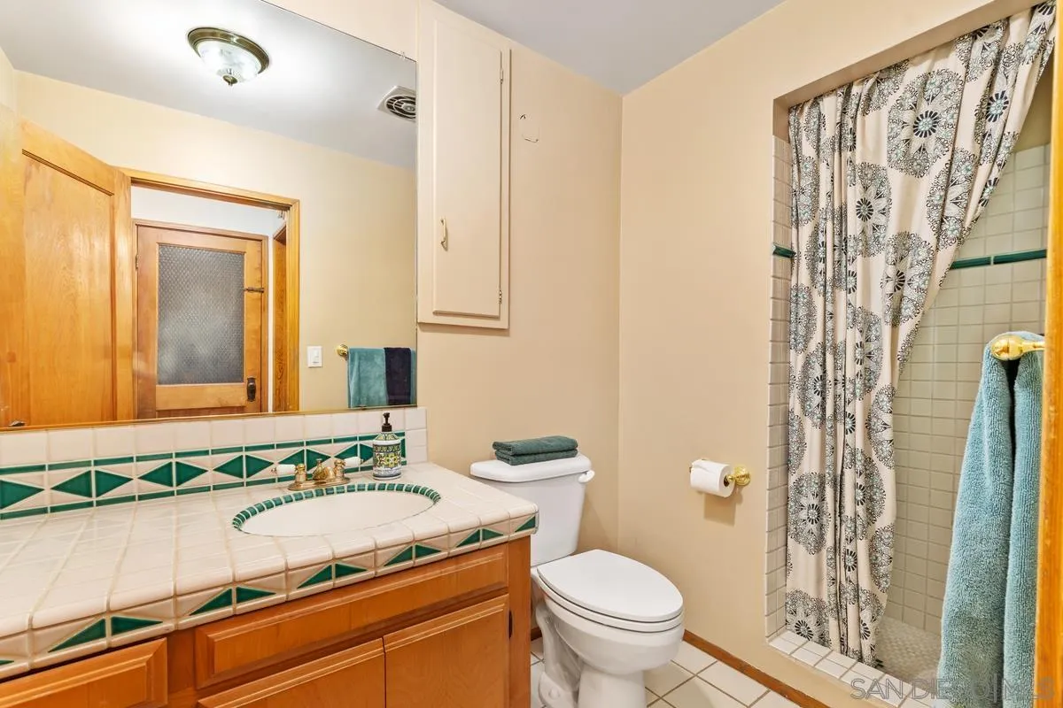1675 Chase Lane El Cajon, CA 92020 - Photo 18 of 32 a bathroom with a granite countertop sink and a mirror