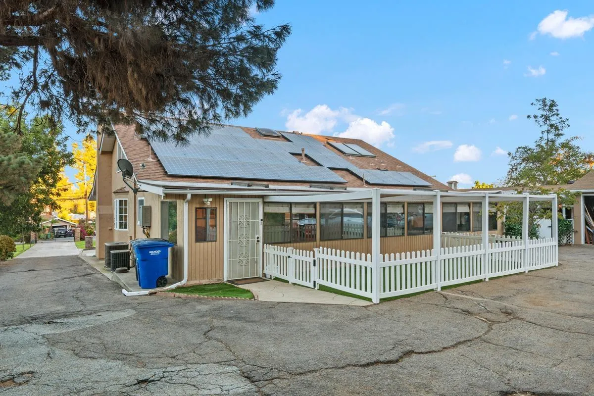 1675 Chase Lane El Cajon, CA 92020 - Photo 32 of 32 a view of a brick house with a large window and plants