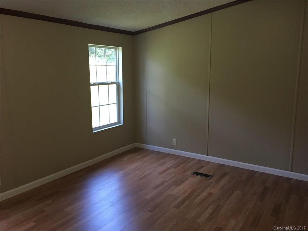 1758 Millen Road Chester, SC 29706 - Photo 4 of 11 an empty room with wooden floor and windows