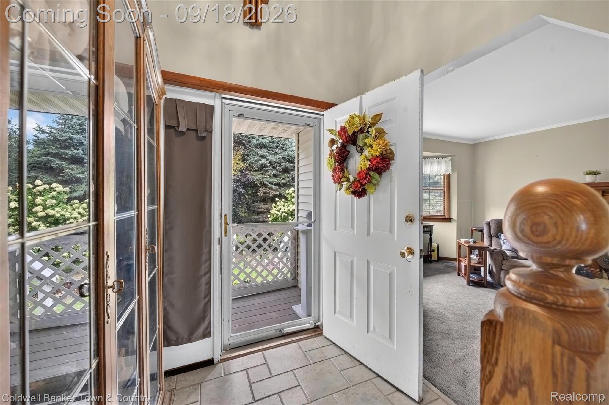 4442 McGunn Road Howell, MI 48843 - Photo 7 of 63 Tiled entryway with a solid wood front door, glass storm door, and adjacent sidelights
