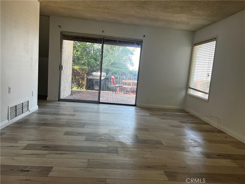 20524 Missionary Ridge Street Walnut, CA 91789 - Photo 6 of 26 a view of an empty room with wooden floor and a window