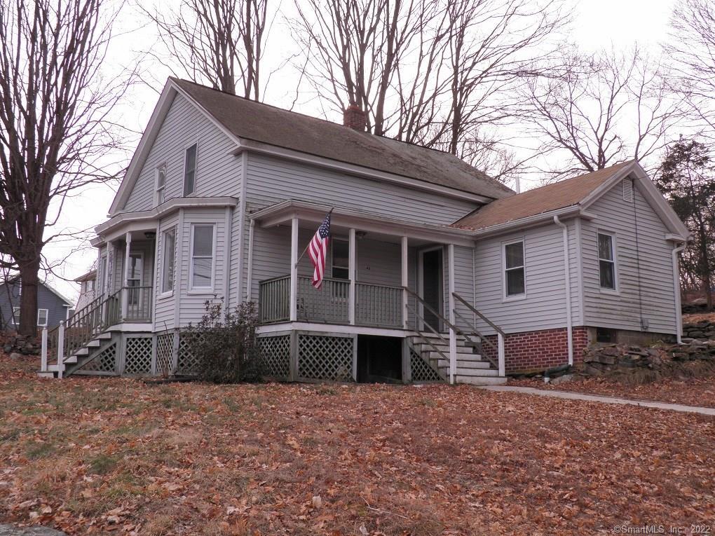 48 Main Street Thompson, CT 06255 - Photo 1 of 1 a front view of a house with a yard and garage