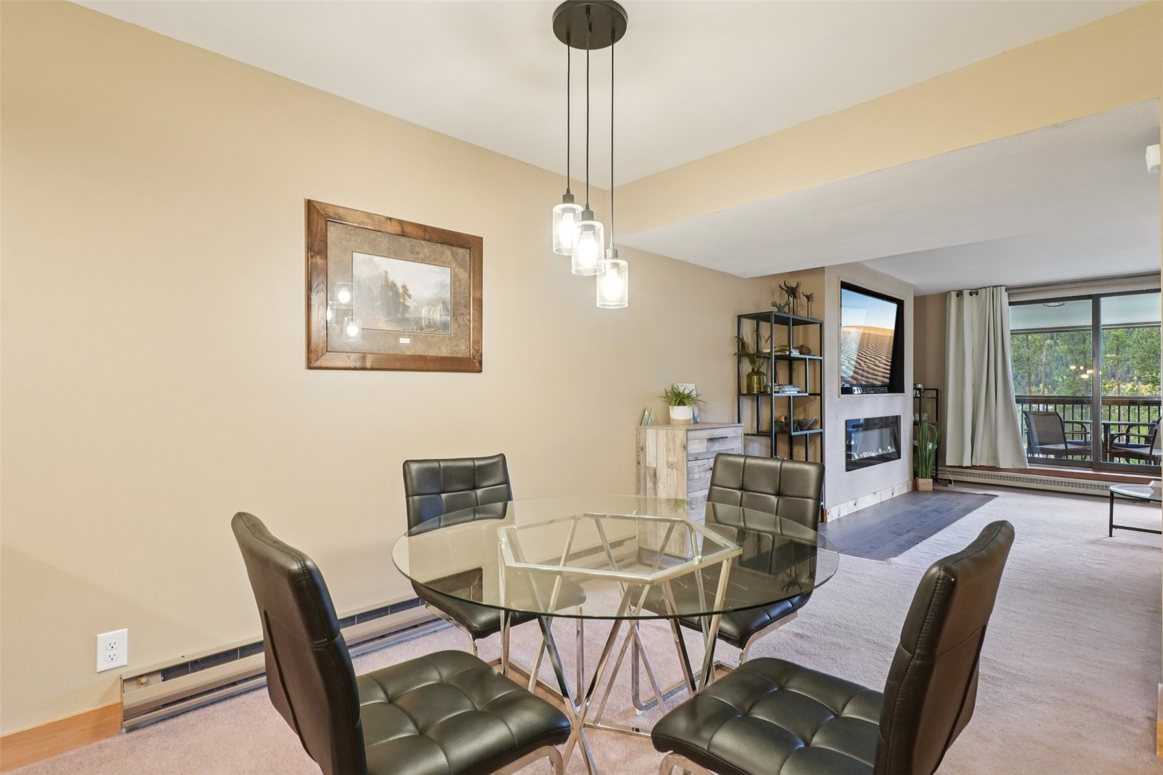 22097 Saints John Road, Unit 2506 Keystone, CO 80435 - Photo 10 of 47 Dining room featuring a glass covered fireplace, carpet flooring, and a baseboard radiator