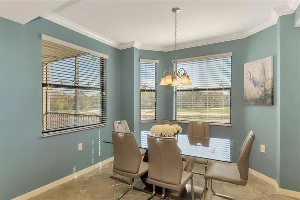 a view of a dining room with furniture a chandelier and wooden floor