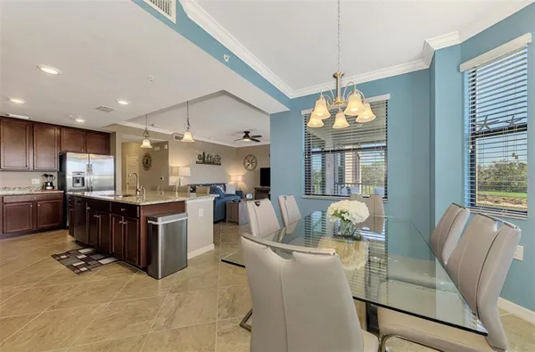 a living room with kitchen island furniture and a chandelier