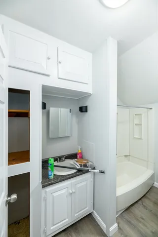 a bathroom with a bathtub and shower