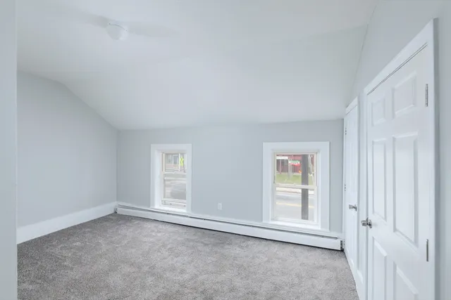 an empty room with a empty space and windows