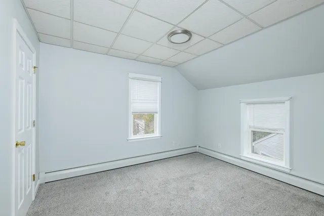 a kitchen that has a sink and a stove with wooden floor