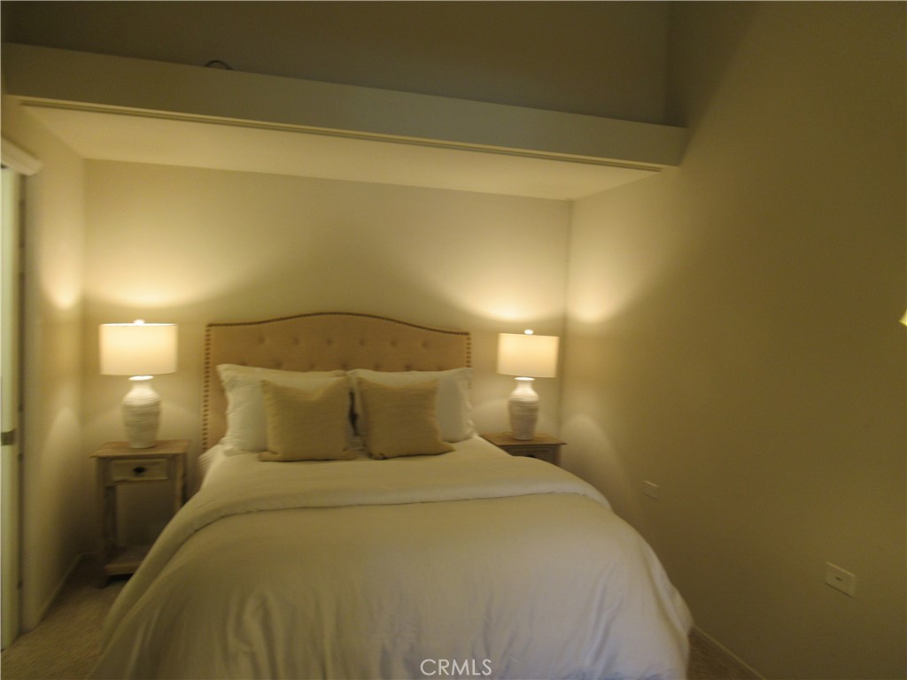 1230 Scioto Road Seal Beach, CA 90740 - Photo 14 of 27 a bedroom with a bed and a night stand