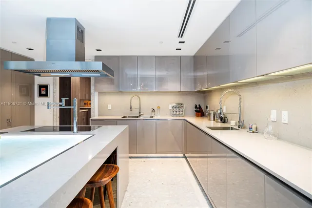 a large kitchen with stainless steel appliances lots of counter space and a sink