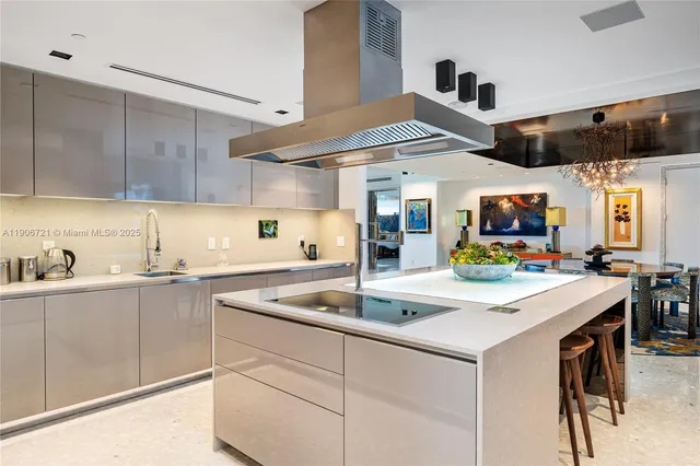 a kitchen with stainless steel appliances granite countertop a sink a stove and cabinets