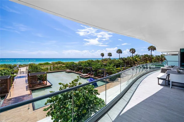 a view of a city from a balcony with outdoor seating