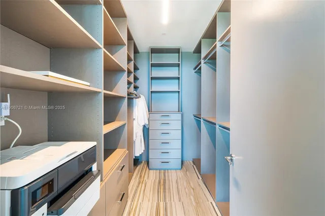 a view of walk in closet with empty racks