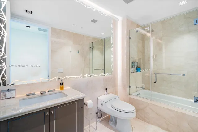 a bathroom with a sink toilet tub and shower