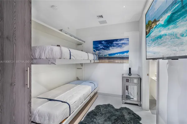 a bedroom with a bed and a painting on the wall