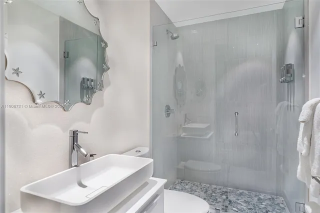 a bathroom with a sink toilet and shower