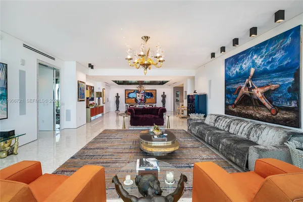 a living room with furniture and a chandelier