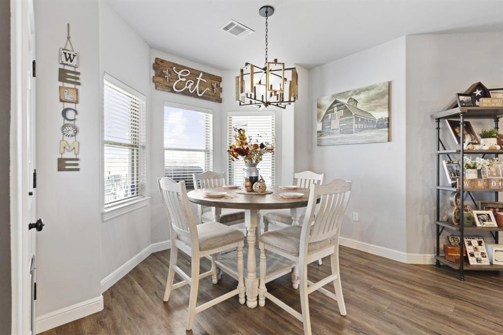 1195 Hog Town Road Collinsville, TX 76233 - Photo 13 of 37 a view of a dining room with furniture wooden floor and a chandelier