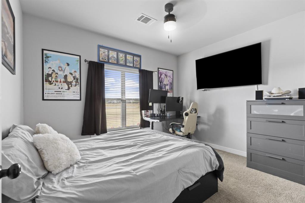 1195 Hog Town Road Collinsville, TX 76233 - Photo 14 of 37 a bedroom with a bed and a flat screen tv