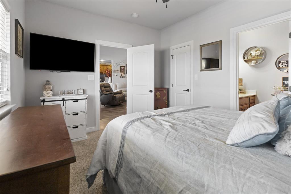 1195 Hog Town Road Collinsville, TX 76233 - Photo 17 of 37 a bedroom with a bed tv and a window