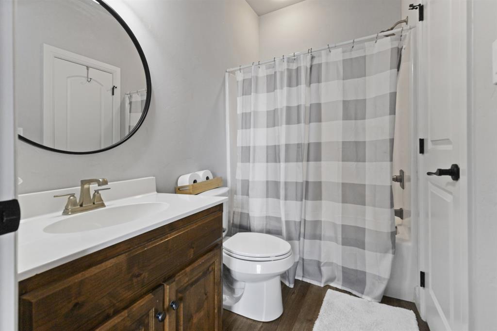 1195 Hog Town Road Collinsville, TX 76233 - Photo 20 of 37 a bathroom with a sink toilet a mirror and shower