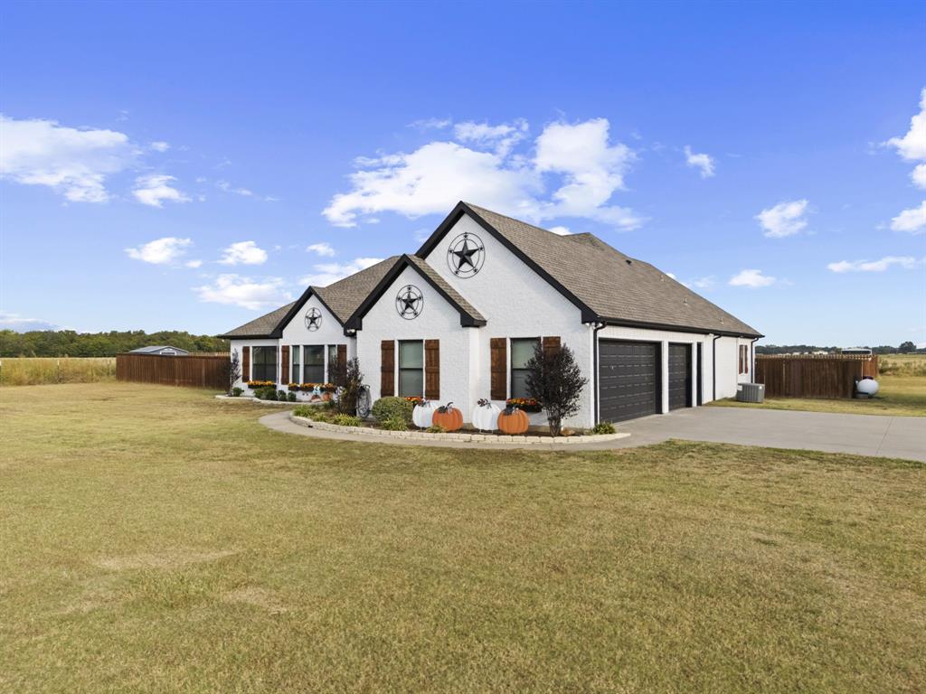 1195 Hog Town Road Collinsville, TX 76233 - Photo 2 of 37 a front view of a house with a yard and balcony