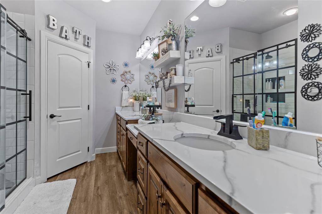 1195 Hog Town Road Collinsville, TX 76233 - Photo 22 of 37 a bathroom with a sink double vanity and a mirror