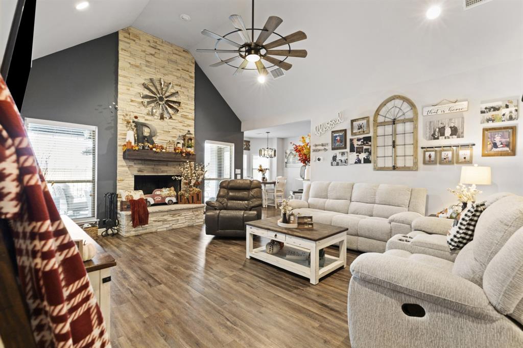 1195 Hog Town Road Collinsville, TX 76233 - Photo 4 of 37 a living room with furniture a fireplace and a flat screen tv