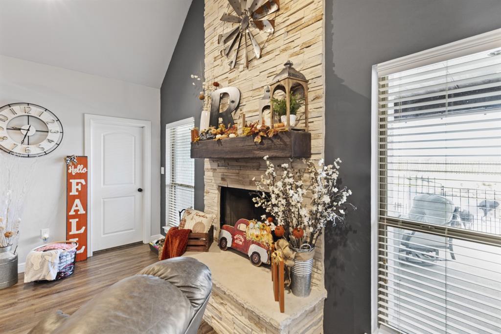 1195 Hog Town Road Collinsville, TX 76233 - Photo 7 of 37 a living room with furniture a fireplace and a window
