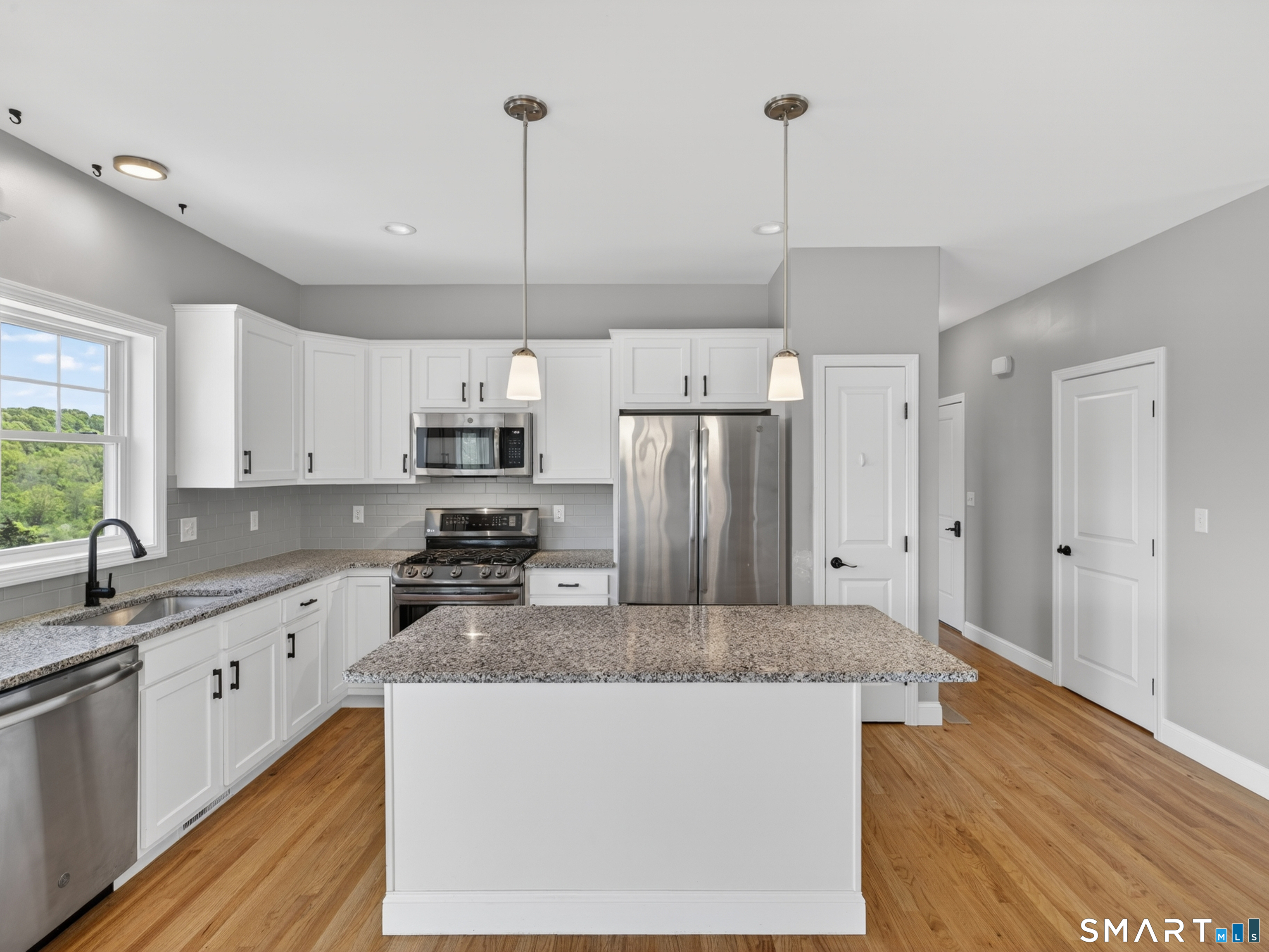 650 Ridgewood Road Middletown, CT 06457 - Photo 13 of 40 a kitchen with kitchen island granite countertop a stove a sink and a refrigerator