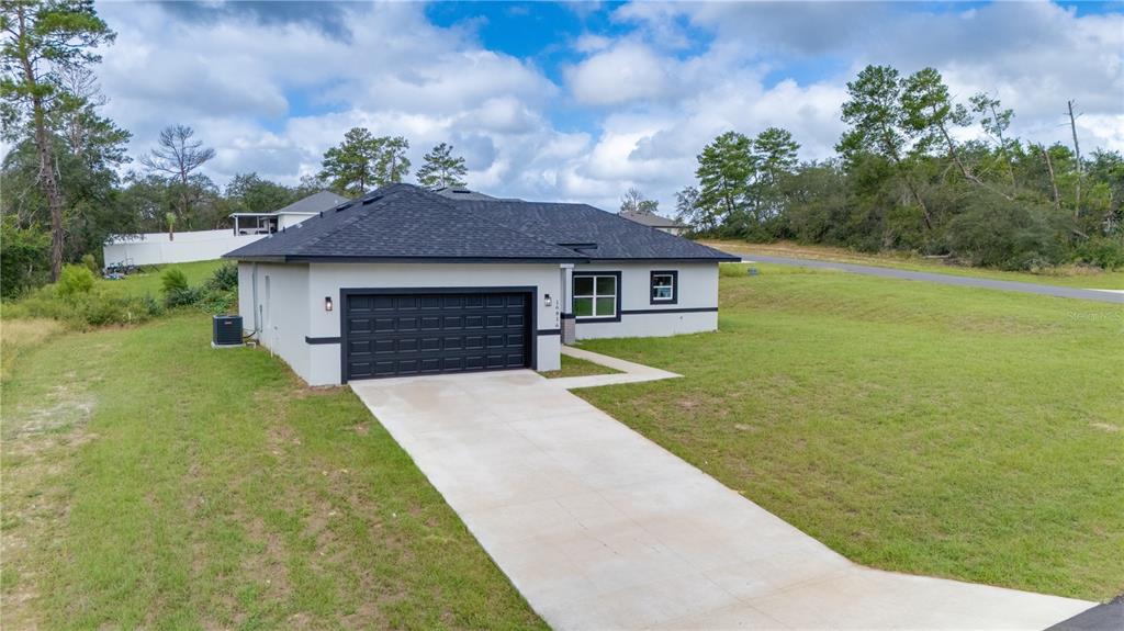 16816 Southwest 41st Avenue Road Ocala, FL 34473 - Photo 2 of 21 a front view of a house with garden