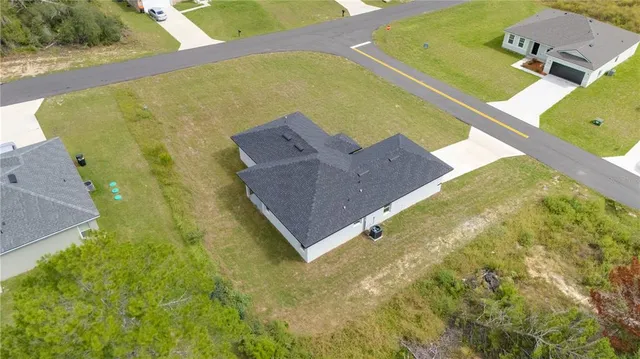 a aerial view of a house with a yard