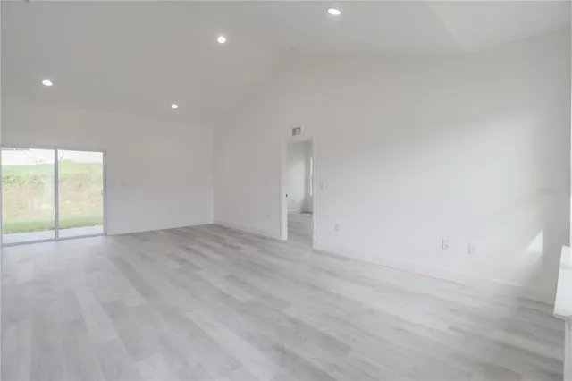 a kitchen with a sink dishwasher and a stove with wooden floor