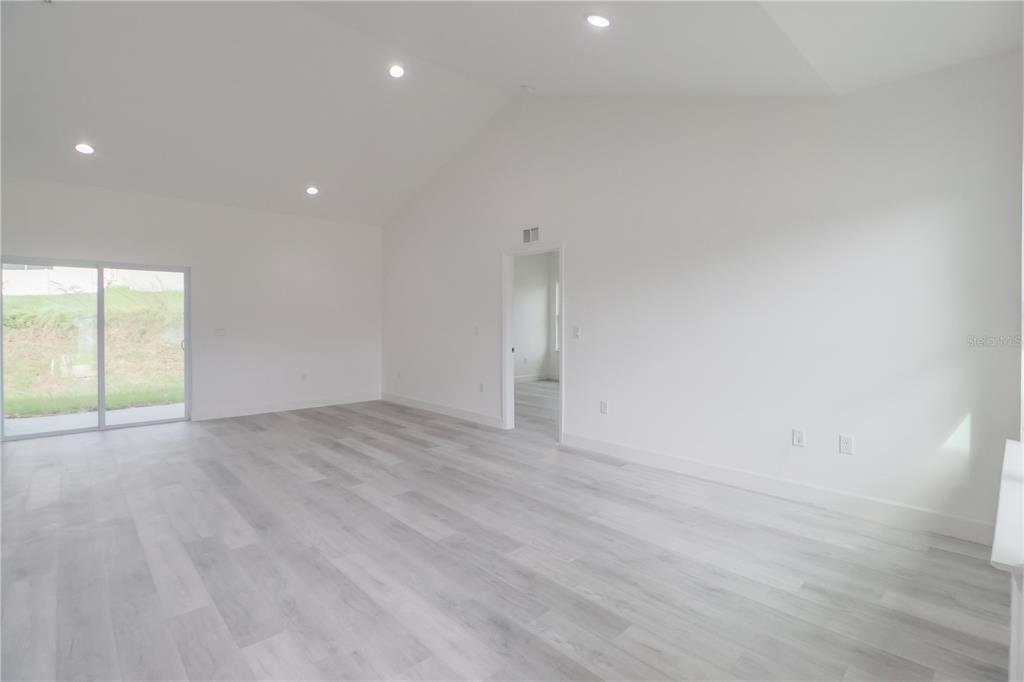 16816 Southwest 41st Avenue Road Ocala, FL 34473 - Photo 8 of 21 an empty room with wooden floor and windows