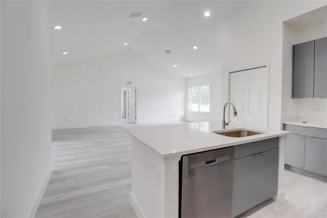 a kitchen with a sink and chandelier