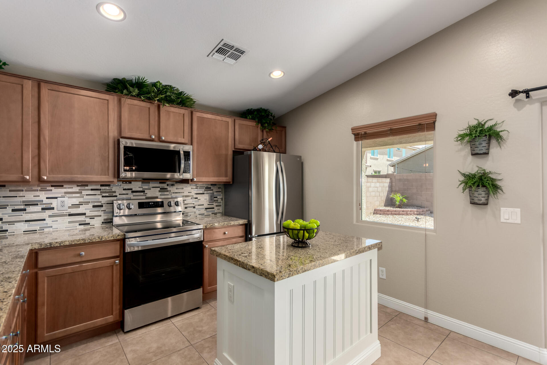 2169 East Gillcrest Road Gilbert, AZ 85298 - Photo 26 of 77 a kitchen with granite countertop a sink stainless steel appliances and counter space