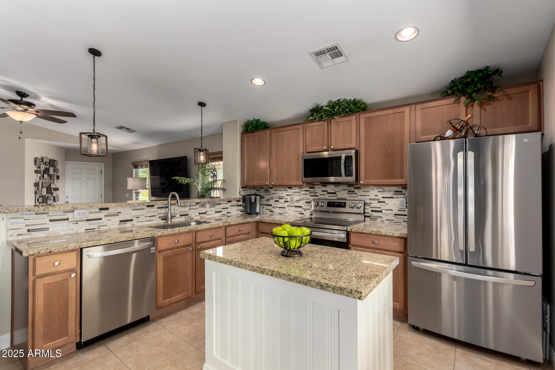 2169 East Gillcrest Road Gilbert, AZ 85298 - Photo 4 of 77 a kitchen with a sink stainless steel appliances and refrigerator