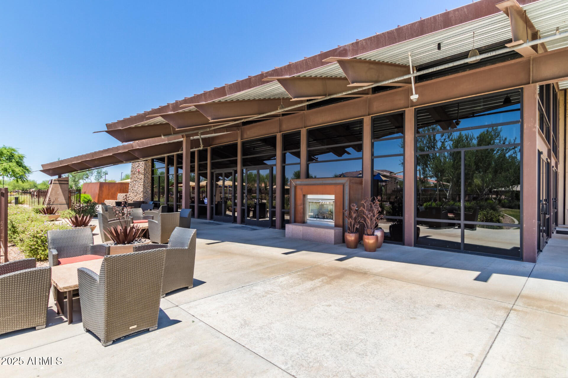 2169 East Gillcrest Road Gilbert, AZ 85298 - Photo 59 of 77 a view of a patio with a table and chairs and potted plants