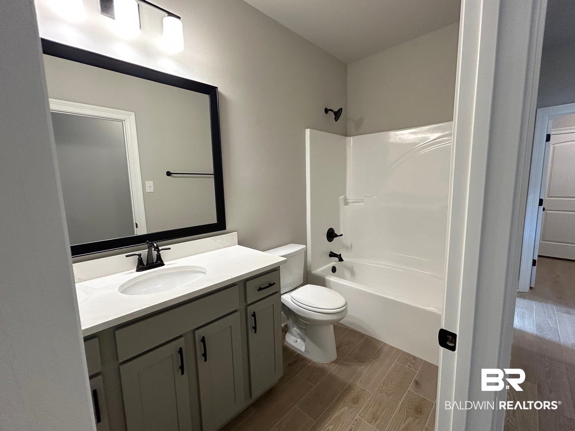 808 Sumter Loop Foley, AL 36535 - Photo 14 of 18 Full bathroom featuring bathing tub / shower combination, toilet, vanity, and hardwood / wood-style flooring
