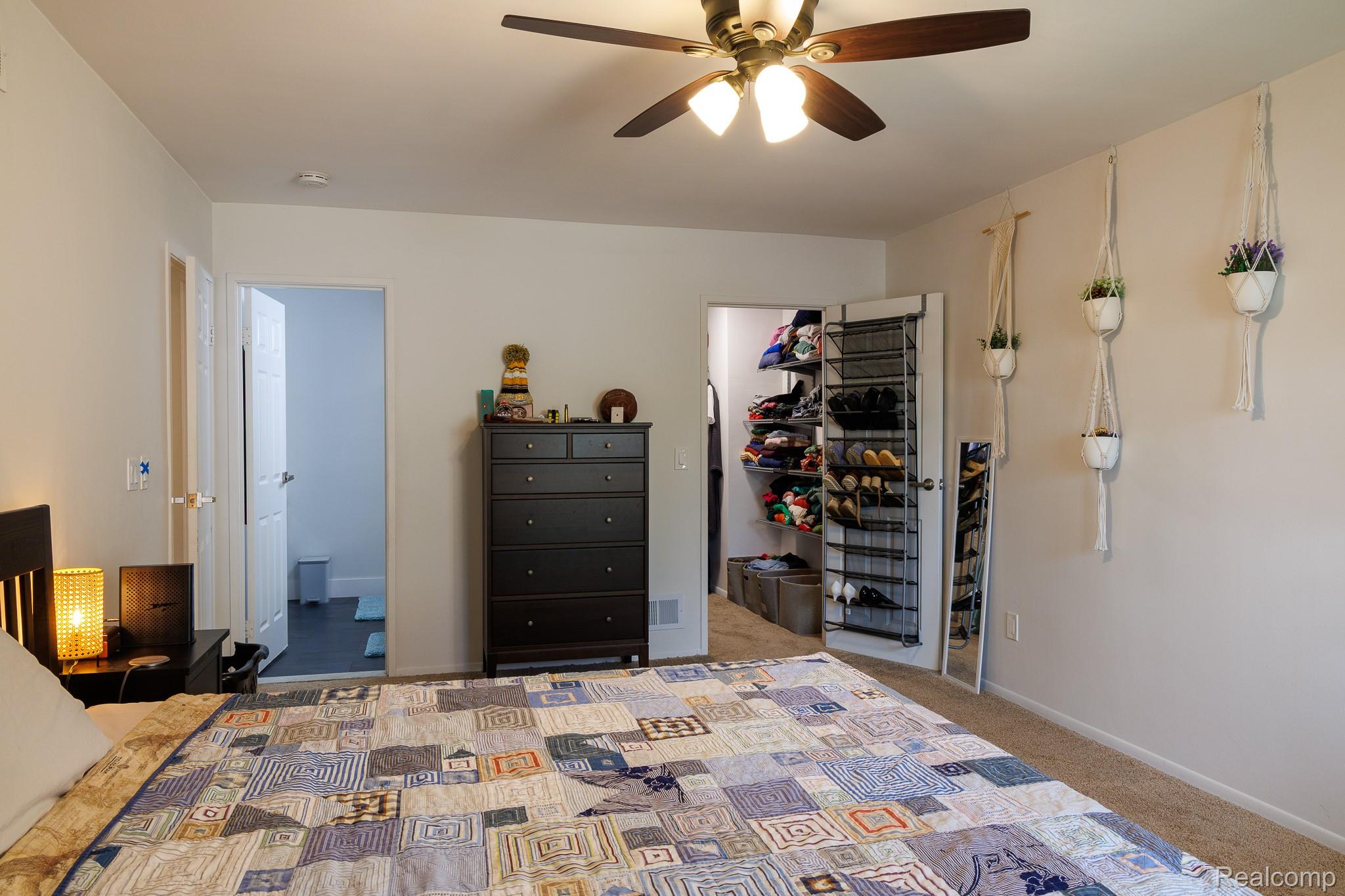 1989 Klingensmith Road, Unit 46 Bloomfield Hills, MI 48302 - Photo 27 of 41 Carpeted bedroom featuring a ceiling fan with light fixture, white walls, and a closet with bifold doors