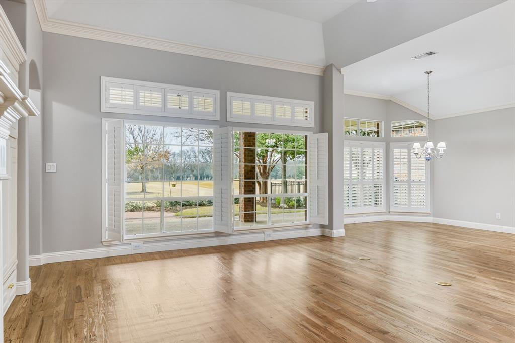 358 Pine Valley Fairview, TX 75069 - Photo 12 of 39 a view of an empty room with wooden floor and a window