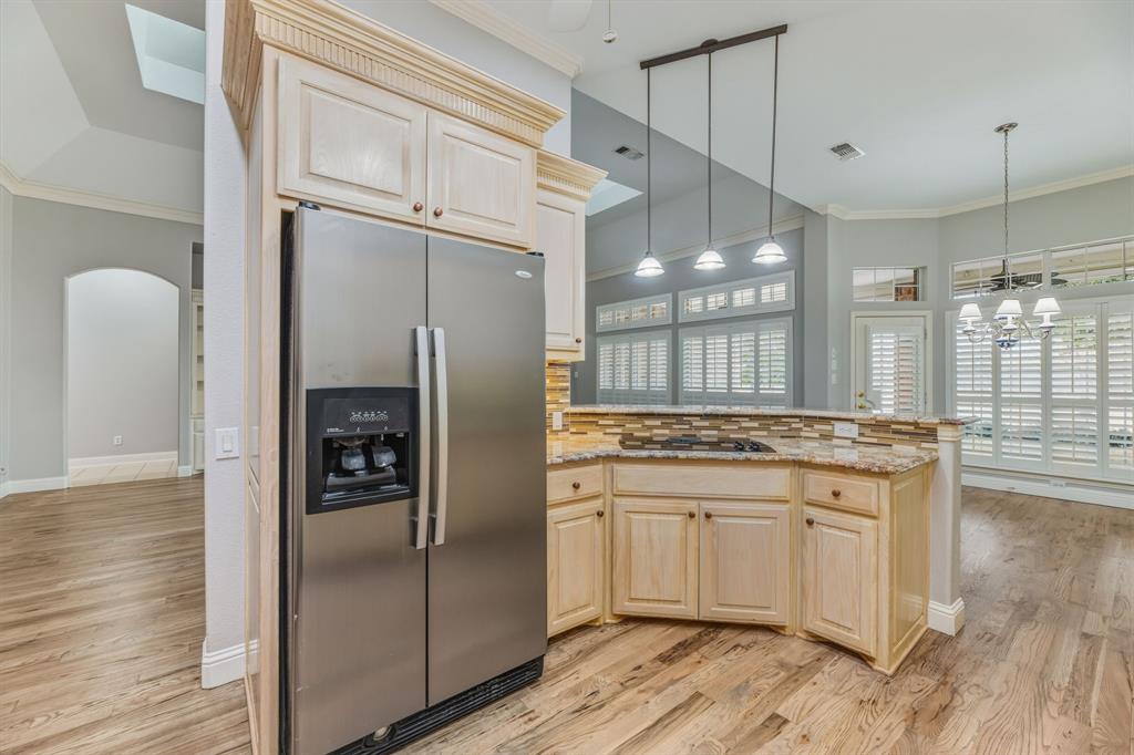 358 Pine Valley Fairview, TX 75069 - Photo 15 of 39 a kitchen with stainless steel appliances granite countertop a refrigerator a sink and a stove