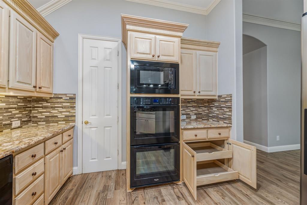 358 Pine Valley Fairview, TX 75069 - Photo 18 of 39 a kitchen with granite countertop a refrigerator stove and oven