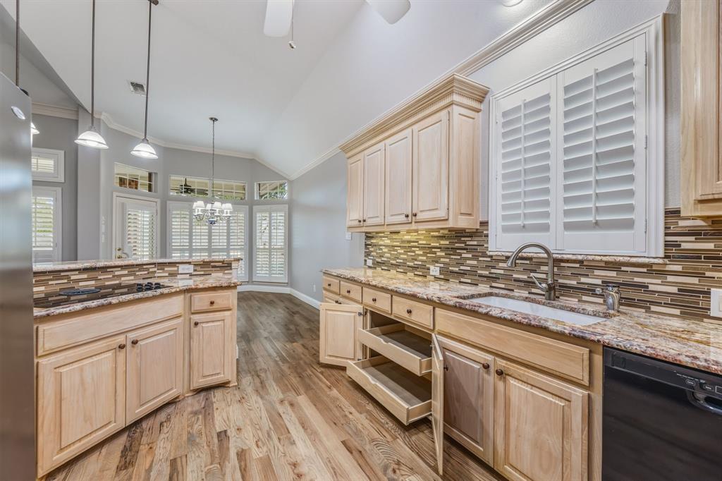 358 Pine Valley Fairview, TX 75069 - Photo 19 of 39 a kitchen with stainless steel appliances granite countertop a stove and a sink