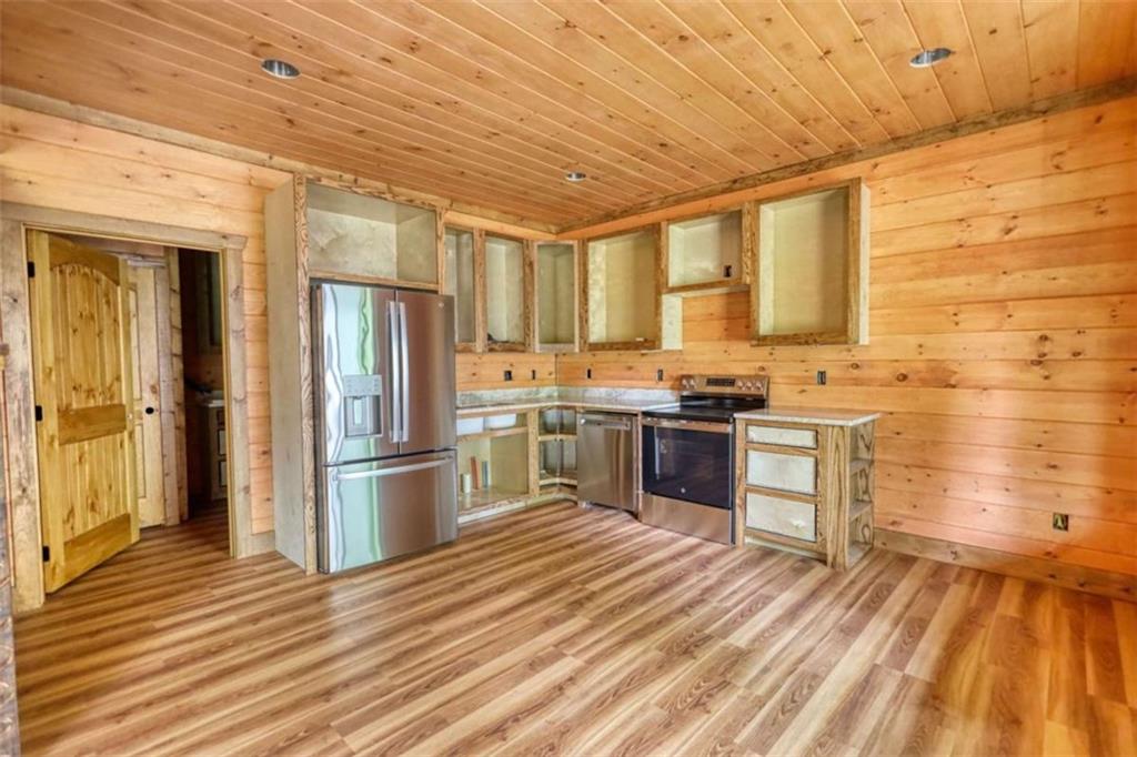 485 Church Street Blue Ridge, GA 30513 - Photo 28 of 85 a kitchen with granite countertop wooden floors stainless steel appliances and sink
