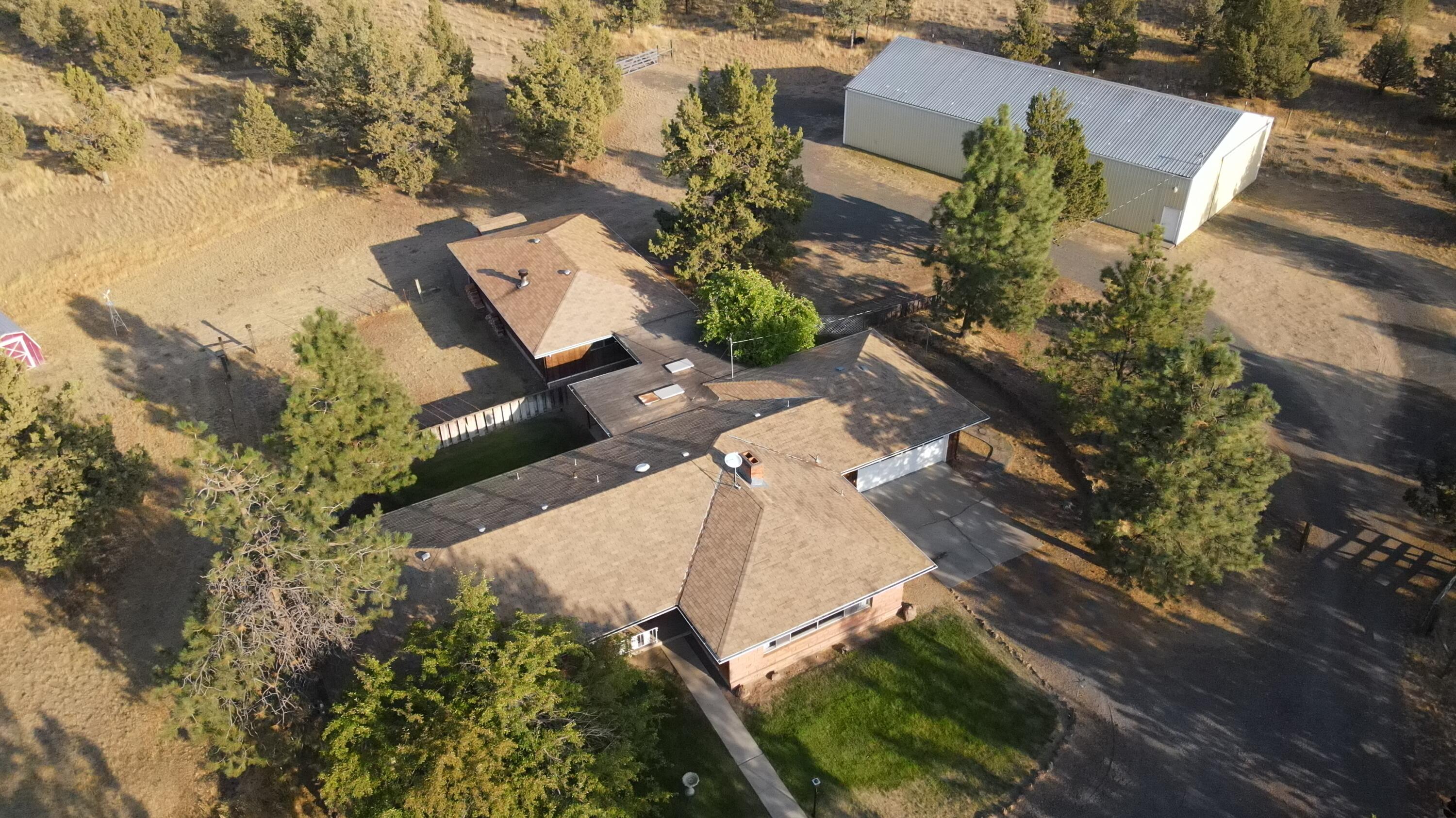 6302 Stillman Road Powell Butte, OR 97753 - Photo 31 of 39 an aerial view of a house with a yard and lake view